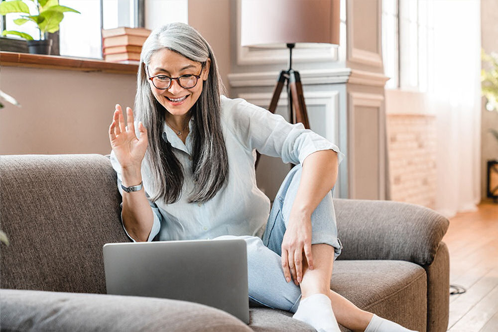 Senior sitting on a couch during telehealth therapy